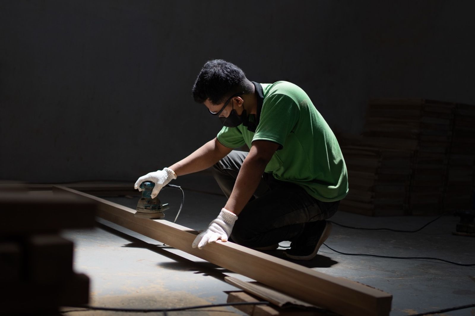 operator using tool to polish wood